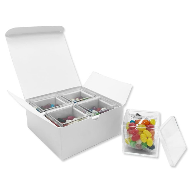 A white gift pack containing four clear cubes filled with colourful jelly beans in various shades.