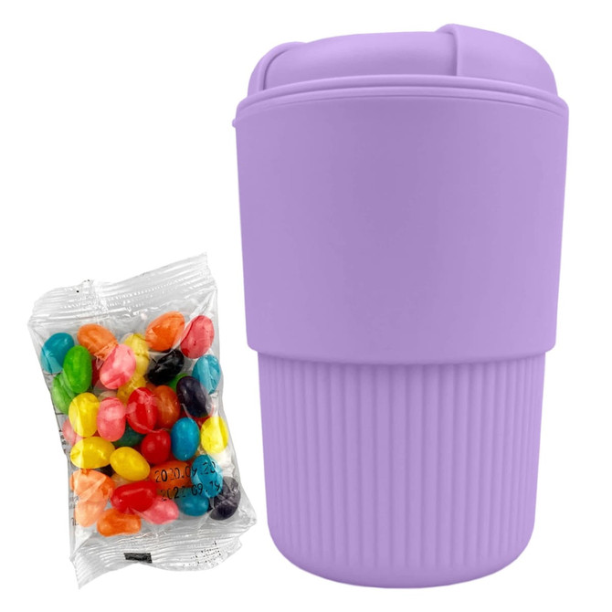A reusable coffee cup in lavender with a ribbed design, accompanied by a packet of colourful jelly beans.