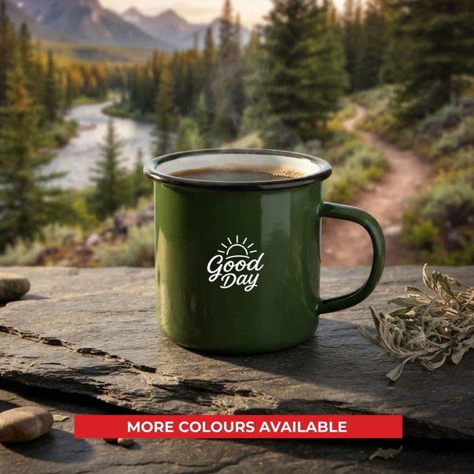A green enamel camper mug with a handle, featuring a logo, set against a natural landscape backdrop.