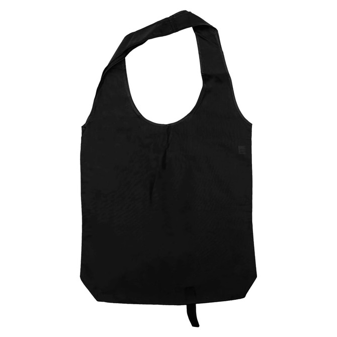 A black tote bag with long handles, featuring a simple design and a small branding logo.