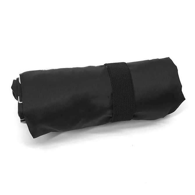 A black tote bag with long handles, rolled and secured with an elastic band, features a logo.