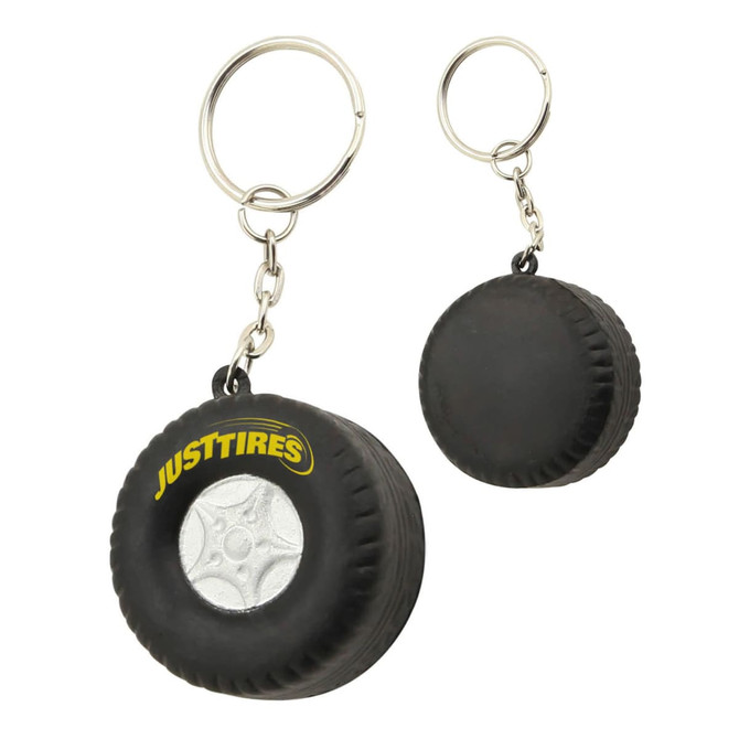 A black stress tyre key ring featuring a small tyre design and a metal keychain attachment, with a logo.