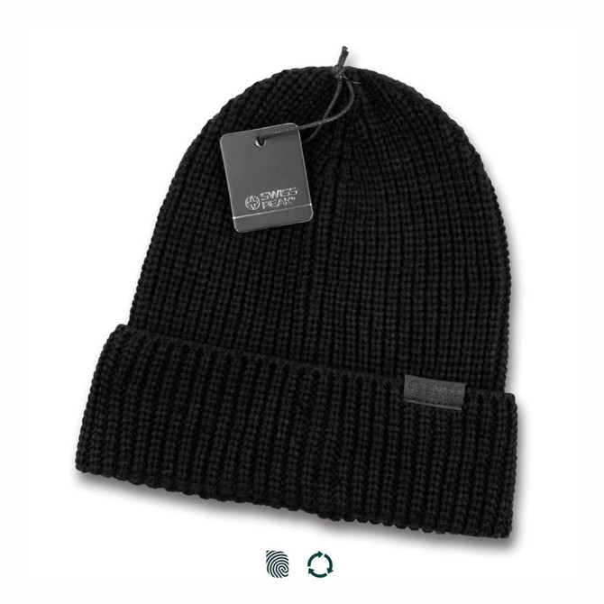 A black knitted beanie with a folded cuff and a tag attached, featuring a branding label.