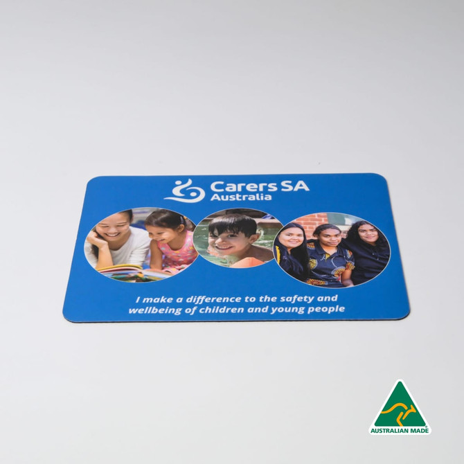 A blue mouse mat featuring images of children and young people, with a logo and text promoting safety and wellbeing.