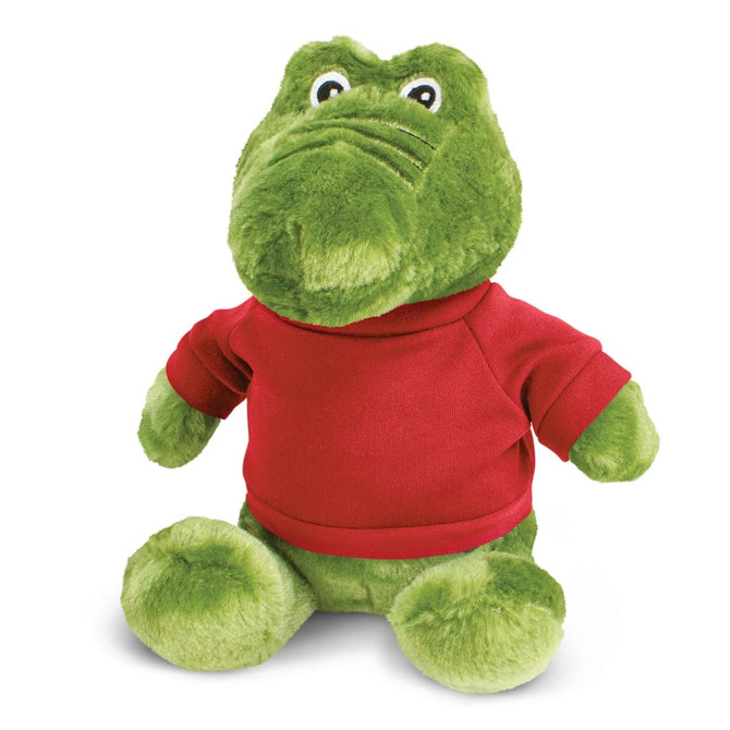 A green crocodile plush toy wearing a red shirt, featuring large eyes and a friendly expression.