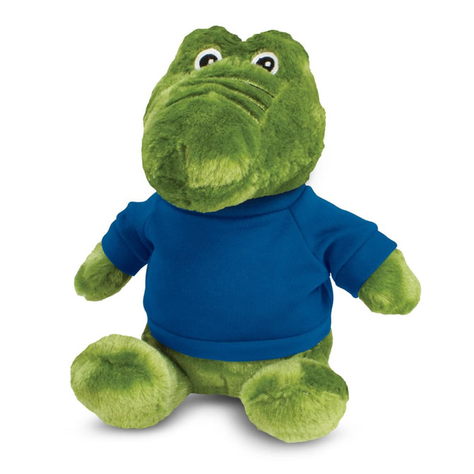 A green crocodile plush toy wearing a blue shirt, with large eyes and a friendly expression.