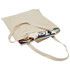 A natural-coloured hemp tote bag filled with magazines. The bag has two handles and a simple design.