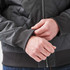 A thermal jacket in dark grey, featuring a quilted design and ribbed cuffs for added comfort.