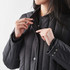 A black thermal jacket with a zip and snap buttons, featuring a fitted design and a soft lining.