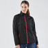 A woman wearing a black rain jacket with red zippers and accents, featuring a collar and side pockets.
