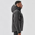 A men's thermal jacket in black featuring a hood, displayed on a model from the side. Includes a logo.