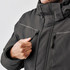 A Men's Steelhead Thermal Jacket in dark grey with zippered pockets and a high collar. Features a logo on the chest.
