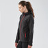 A black softshell hoody with red zippers and a hood, featuring a logo on the chest.