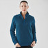 A woman is wearing a teal women's Montebello thermal 1/4 zip pullover, featuring a collar and long sleeves.