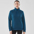 A woman in a teal quilted thermal 1/4 zip pullover, with a stand-up collar and raglan sleeves.
