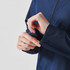 A navy blue women's rain jacket with a quarter zip and adjustable cuffs. Features a logo on the fabric.