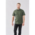 A man models a green button-up shirt with short sleeves, paired with dark jeans. The shirt features a logo.