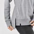 A grey women's pullover featuring a cowl neck and side slits, with a branded tag on the hem.