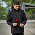 A black softshell jacket with red zippers and a hood, featuring a logo on one side.