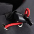 A close-up of a black softshell jacket featuring a red drawcord and toggle for adjustment, with a brand logo present.
