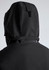 A black rain jacket featuring a hood and a rear zipper detail. The jacket includes branding.