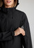 A black women's jacket featuring a hood and an arm pocket for storage, with a logo on the sleeve.