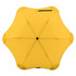 A yellow BLUNT Metro Umbrella with a unique hexagonal shape and a central button, featuring a logo on the canopy.