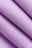 A close-up of folded, soft fabric in a light purple hue, showcasing its smooth texture and weave.