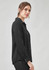 A black long sleeve shirt with a button-down front and a relaxed fit. It features a collar and long sleeves.