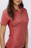 A red ladies' polo shirt featuring a textured design and a collar. It has a fitted silhouette and includes a branding logo.