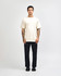 A model wearing a lightweight off-white unisex t-shirt paired with blue jeans and white sneakers, featuring a logo.