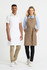 A white apron worn by a man and a khaki apron worn by a woman, both paired with casual shirts and pants.