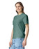 A green heavyweight t-shirt is displayed on a model, featuring a casual fit and a simple design.