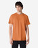 An orange Gildan Ultra Cotton adult T-shirt displayed on a model, featuring a round neck and short sleeves.