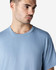 A man wearing a light blue Gildan Ultra Cotton adult T-shirt, featuring a round neckline and short sleeves.