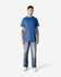 A blue Gildan Ultra Cotton adult t-shirt displayed on a model wearing light jeans and white shoes.