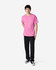 A pink Gildan Ultra Cotton adult T-shirt displayed on a model wearing black pants and shoes, featuring a logo.
