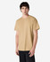 A man wearing a plain khaki Gildan Ultra Cotton adult T-shirt, standing against a white background.