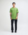 A unisex fine jersey short sleeve T-shirt in vibrant green, worn by a model in casual denim. It features a logo.