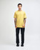 A model wearing a yellow unisex fine jersey short sleeve t-shirt and loose blue denim jeans, hands in pockets.