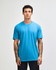 A blue unisex short sleeve T-shirt displayed on a model against a plain background, featuring a logo.