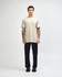 A unisex short sleeve T-shirt in beige, paired with black cargo pants, featuring a logo on the shirt.