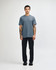 A short sleeve unisex t-shirt in a blue shade, paired with black cargo pants, featuring a logo.