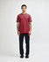 A maroon unisex CVC short sleeve t-shirt worn by a model, paired with black cargo pants. The model has a casual stance.