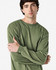 A long sleeve t-shirt in olive green, featuring a simple design and a logo on the front.