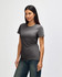 A grey Gildan Softstyle ladies' t-shirt displayed on a model, featuring a fitted design and short sleeves.