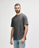 A midweight adult t-shirt in dark grey, featuring short sleeves and a relaxed fit. It has a logo on the front.