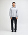 A unisex grey hooded sweatshirt with a kangaroo pocket, paired with light blue jeans and black sneakers.