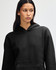 A black unisex hooded sweatshirt with a front pocket and a relaxed fit. It features a logo on the garment.