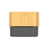 A Bluetooth speaker with a bamboo exterior and a dark gray base featuring control buttons for playback.